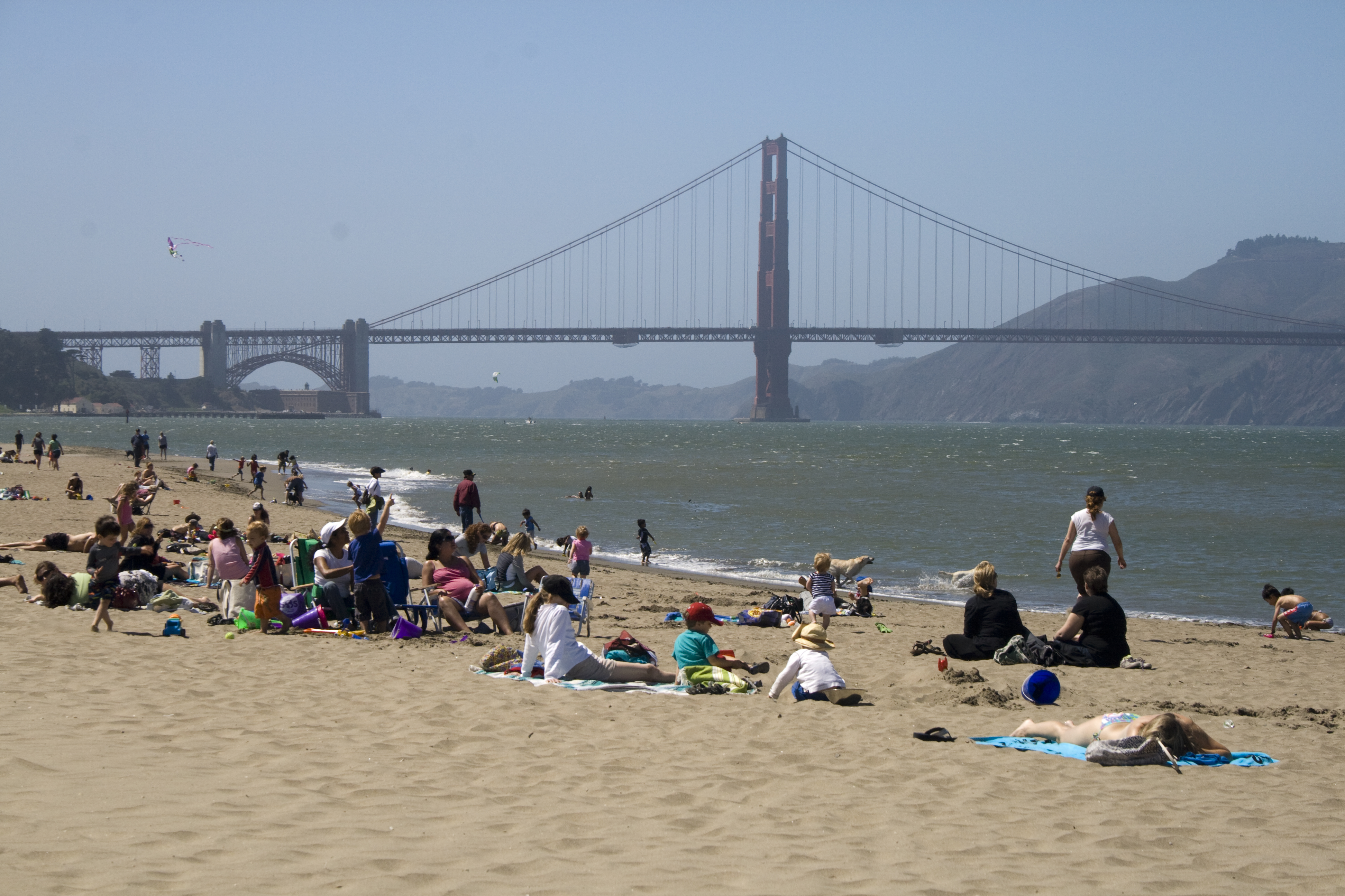 Crissy Field's East Beach People on the beach with the golden gate bridge and the ocean in the background