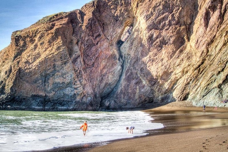 Tennessee Beach A couple children stand on a beach with a rocky cliff in background