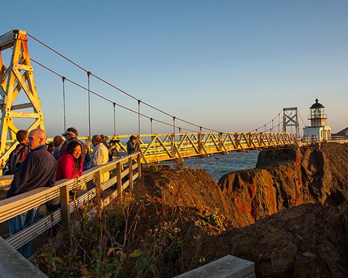 Point Bonita with visitors near the suspension bridge during sunset