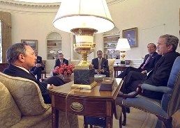 New York Governor George Pataki and New York Mayor Michael Bloomberg and President George W. Bush discuss the federal transfer of Governors Island to the people of New York, April 1, 2002.