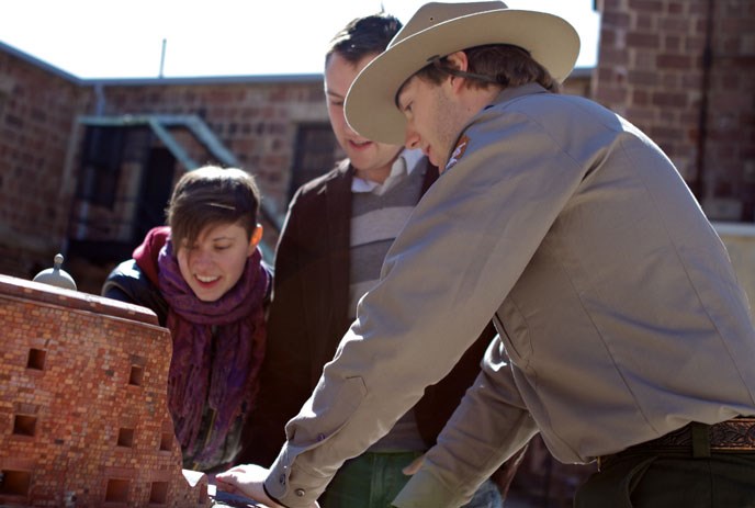 A ranger shows visitors one of the exhibits in Castle Williams