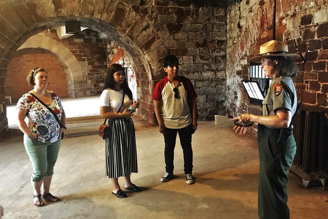 A ranger leading a tour inside Castle Williams