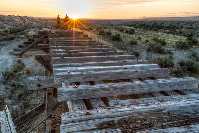 Sunset by an old railroad trestle.