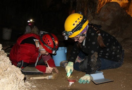 Kids digging 2017 Lint Camp Kids cleaning cave floor