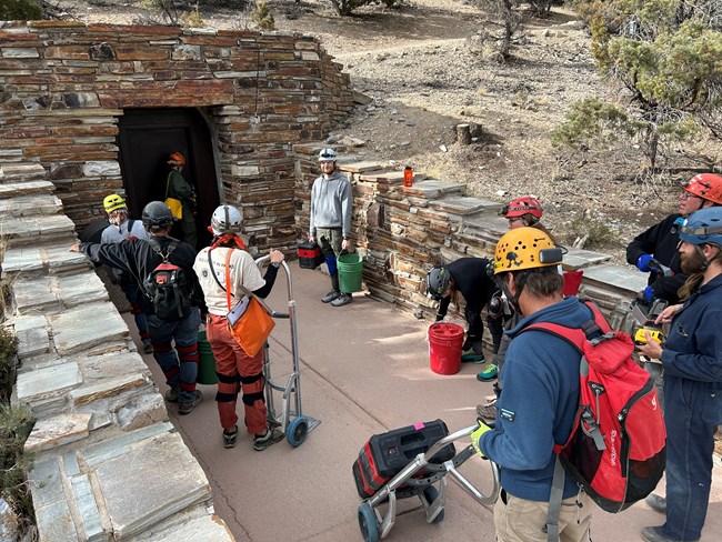 Group of people and supplies outside exit tunnel