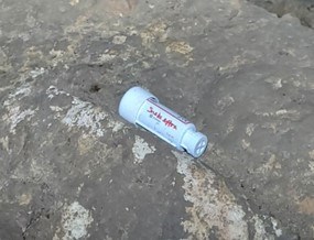 white cylindrical tube on cave mud
