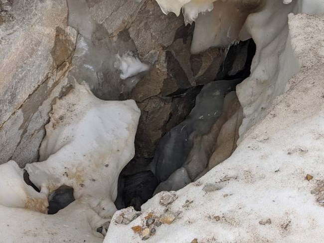 Glacial crevasse with ice and snow