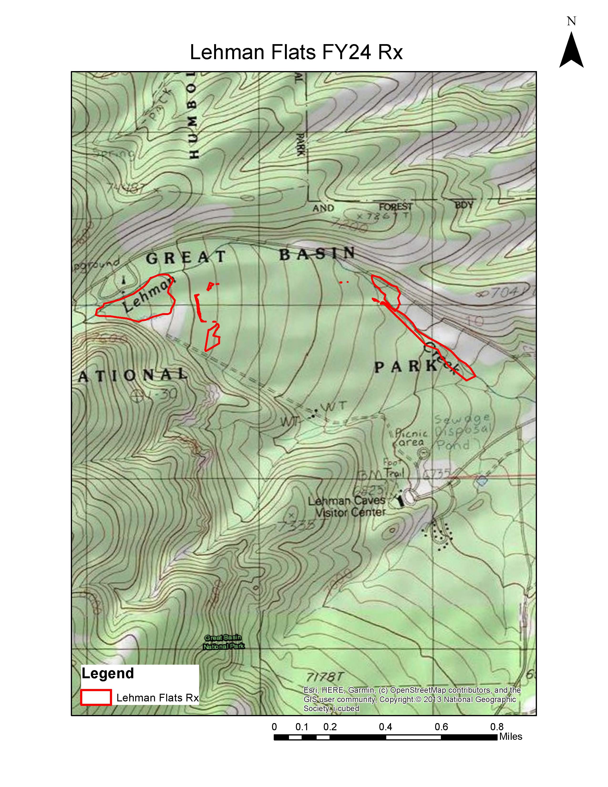 A color image of a topographic map. The focus is on several small areas bordered by red near a road.