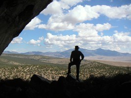 Silhouetted person looking out on the valley