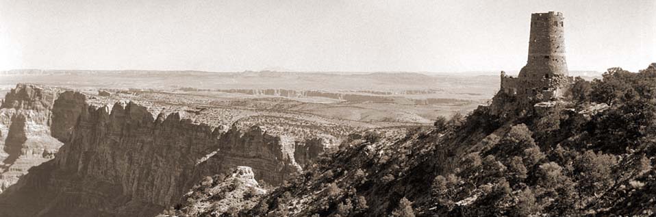 Sepia toned image of Desert View Watchtower on the far right, looking out over Grand Canyon cliffs beyond. Sepia toned image of Desert View Watchtower on the far right, looking out over Grand Canyon cliffs beyond.
