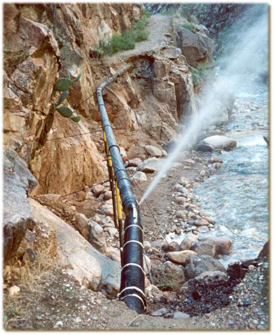 Water sprays out from a break in the Transcanyon waterline.