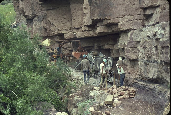 A contracted construction crew and equipment crushing rock in preparation for installation of the Transcanyon Waterline in 1965.