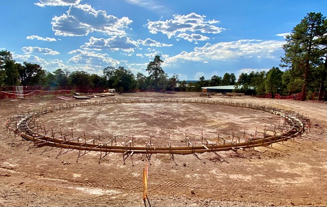 water tank footings View of circular shaped trenched area in the dirt with wood and rebar inserted for concrete pouring
