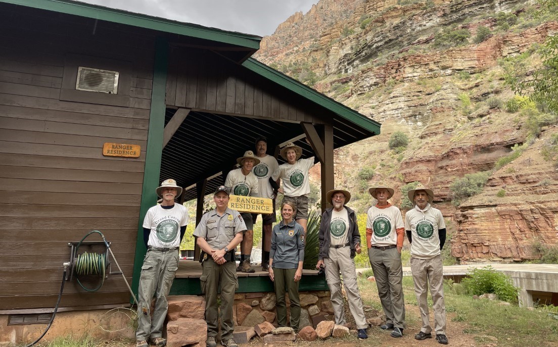 A group of volunteers stands in front of the Manzanita Ranger Station