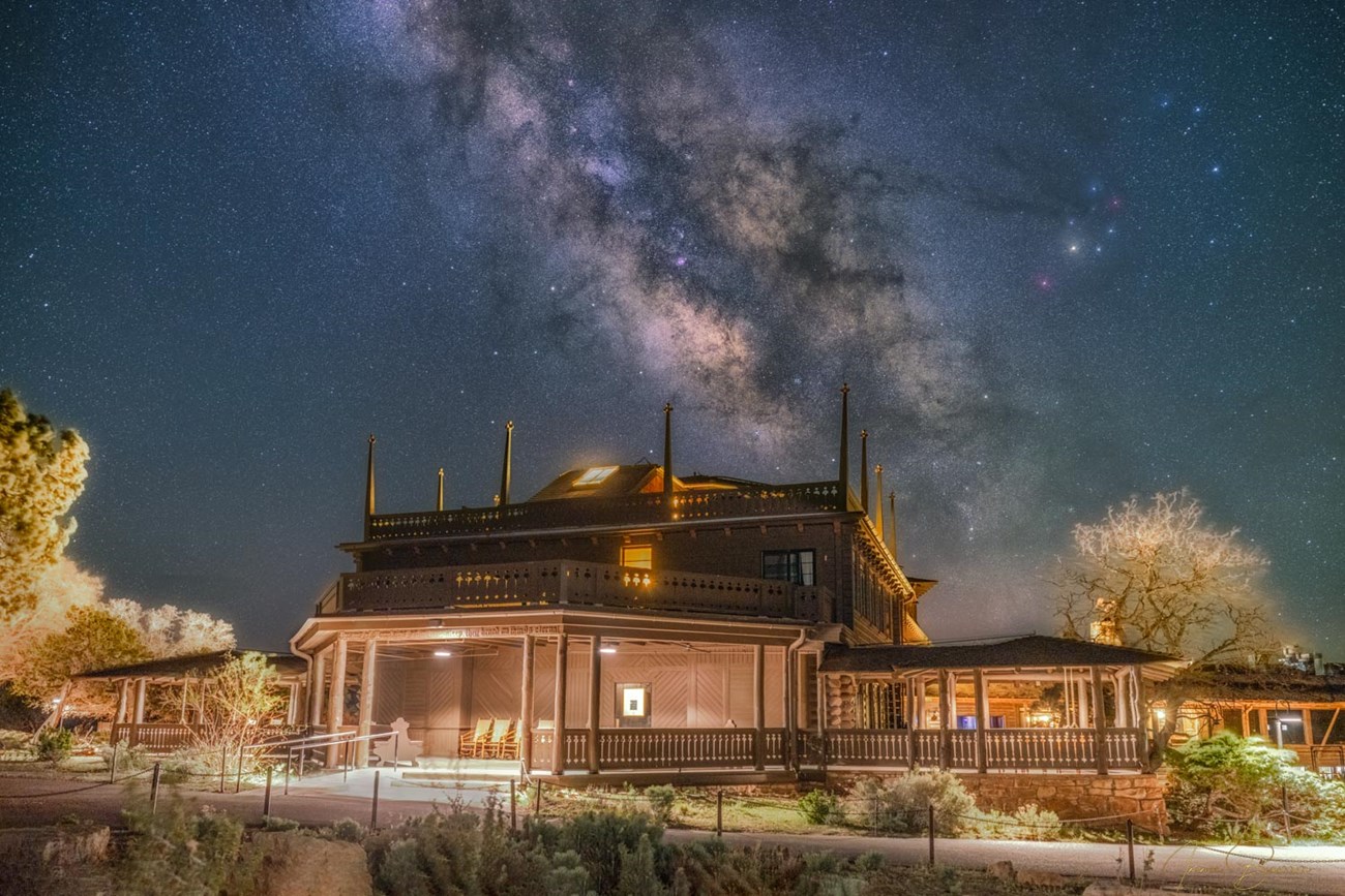 Wooden hotel called El Tovar with Milky Way in the sky