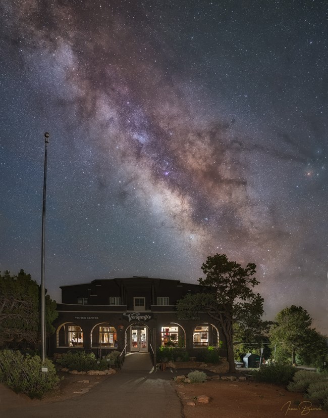 A wooden house with the Milky Way in the background.