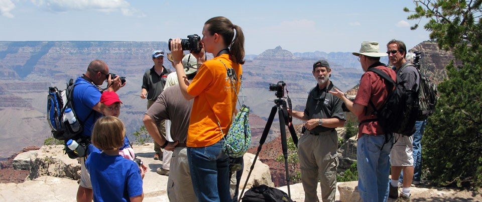 Photography on the South Rim. A group of photographers with tripods mingle on a scenic overlook.