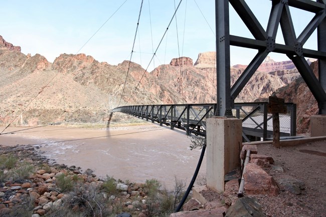 A foot bridge crossing a river.