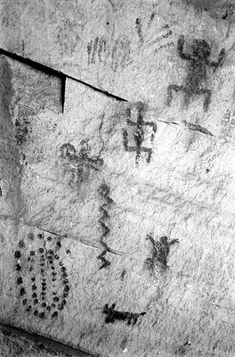 Black and white image of pictographs, or painting on rocks.