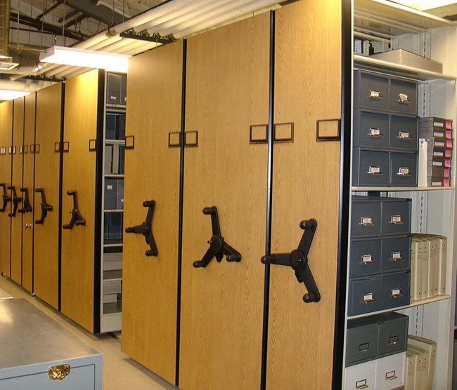 view of archive room with records stored in space-saver storage racks, 3/4 view of storage.