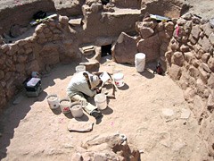 Archeologist uncovering a kiva.