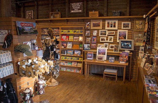Image of bookstore showing various books, gifts, and photos displayed on shelves and cabinets.