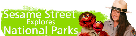 Elmo, Murray and ranger Amala to the right of a green banner that reads - Sesame Street Explores National Parks. Elmo, Murray and ranger Amala to the right of a green banner that reads - Sesame Street Explores National Parks.