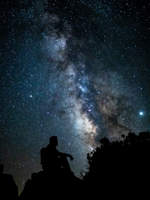 A visitor enjoying Grand Canyon’s starry skies