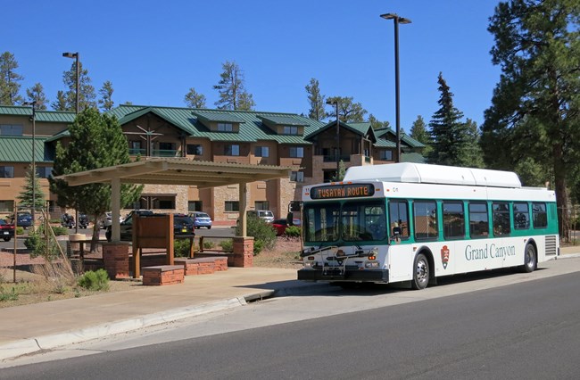 A Grand Canyon National Park shuttle bus stops for passengers at a stop in Tusayan.