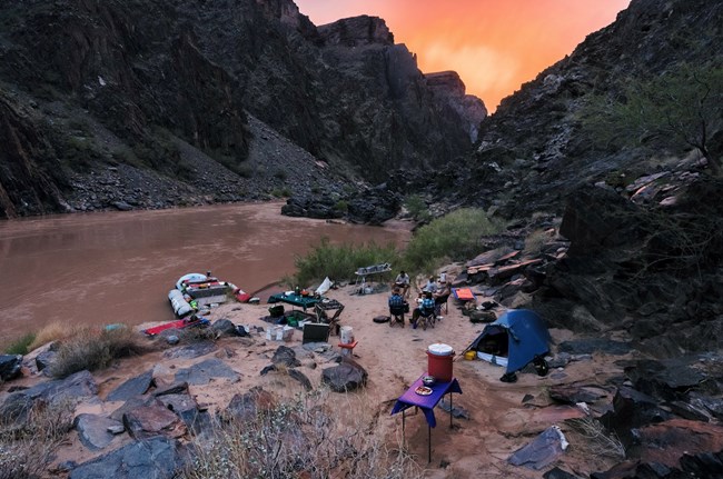 Park rangers camp along the Colorado River while conducting a river patrol.