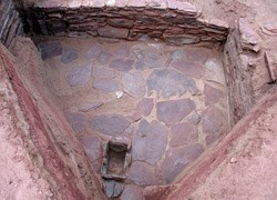 a masonry room and small slab-lined feature.