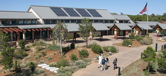 Visitors walking past the S. Rim Visitor Center.