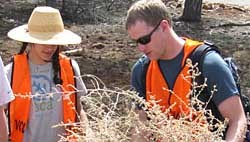 2 SCA volunteers holding tumbleweed.