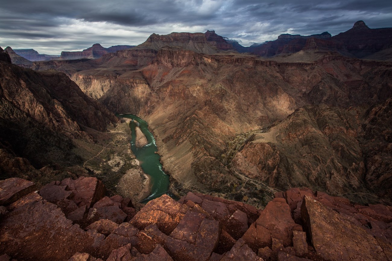 Green, low-sediment water flowing in the Colorado River post-dam