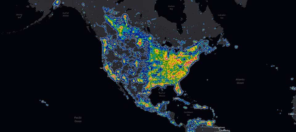 Map of North America as seen from space. Bright areas on this map show skyglow from artificial lighting. The area east of the Mississippi river is brighter than the western half