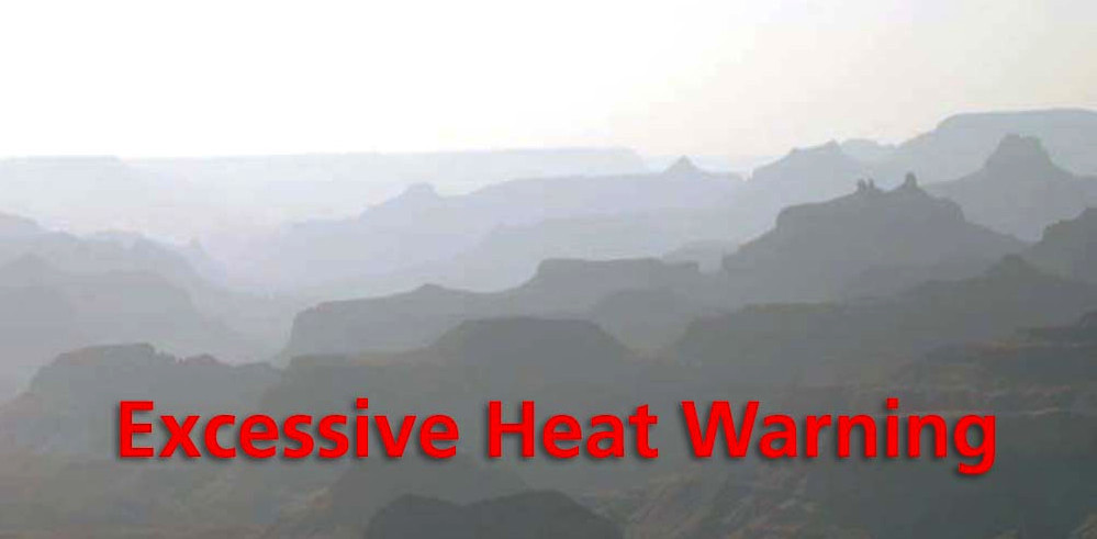 Bright, hazy scene of silhouetted buttes and ridgelines with the words: Excessive Heat Warning across the bottom in red letters.