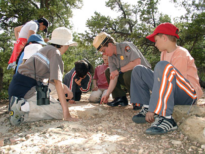 Allyson Mathis, Science and Education Outreach Coordinator, teaches young visitors about fossils in Grand Canyon National Park