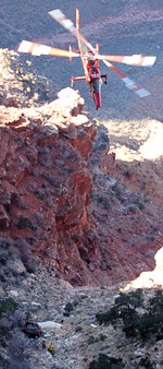 Red Chrysler Crossfire being extracted from Grand Canyon by KMax heavy lift helicopter and the NPS Rangers.