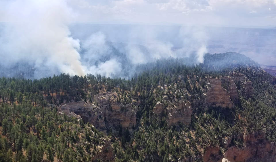 Smoke from several fires burning on a forested plateau above a canyon wall on July 24, 2018.