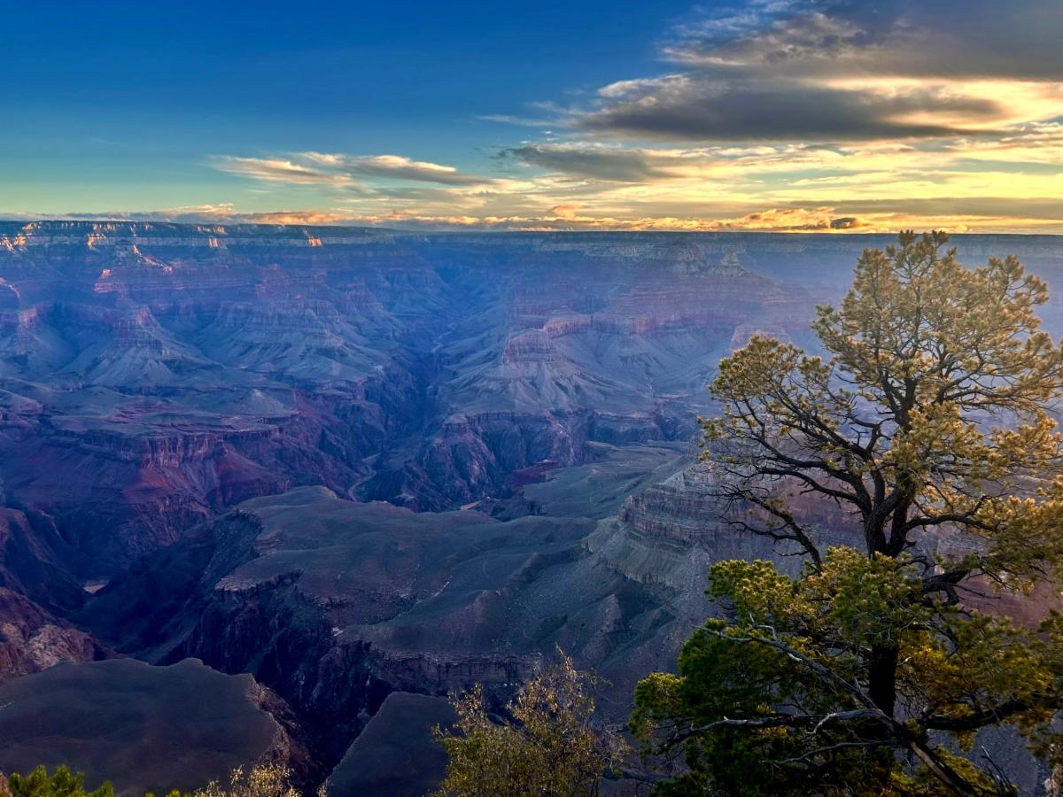 during sunrise, looking down into a vast mile deep canyon filled with peaks and ridgelines