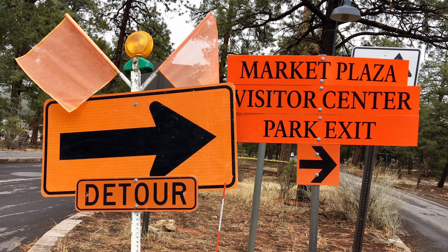 orange detour signs and flags direct visitors