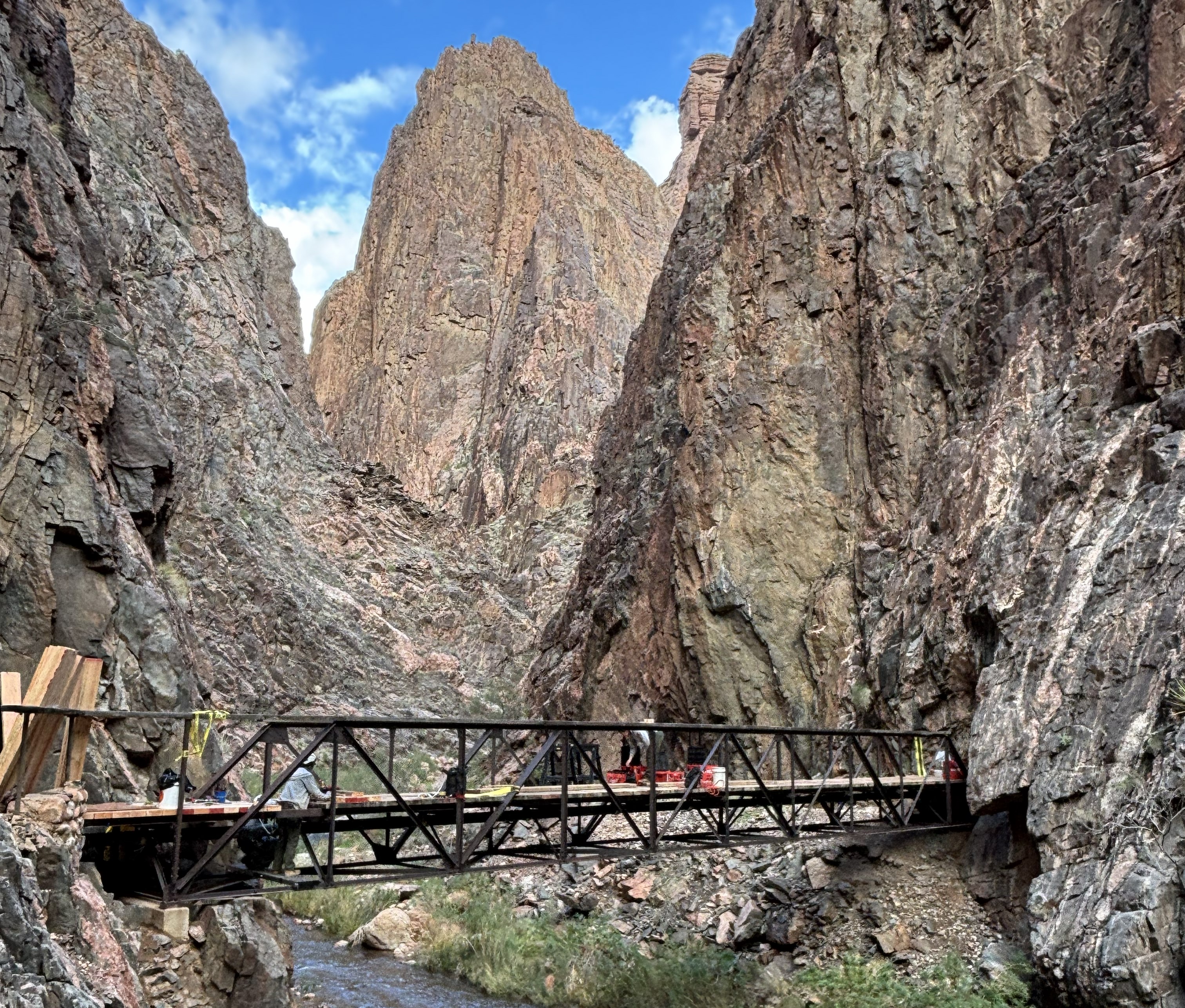 A bridge with tall spires across a creek