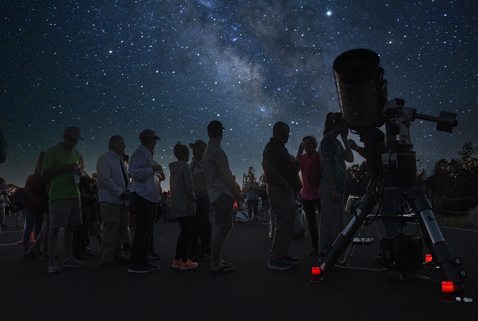 Star Party-South Rim A group of people gather around a telescope with the night sky above