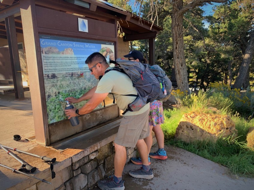 Hikers fill water bottles near the Bright Angel Trailhead on the South Rim