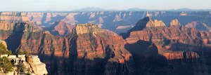 Inner canyon red and brown peaks with mountains in the far distance