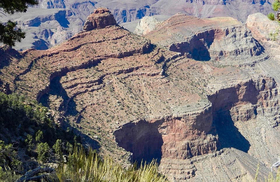 A butte with sloping sides that end abruptly in sheer cliff walls.