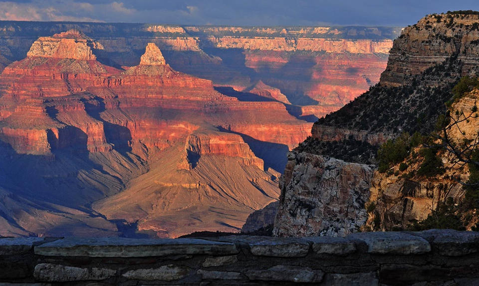 The setting sun casts shadows inside Grand Canyon while looking north