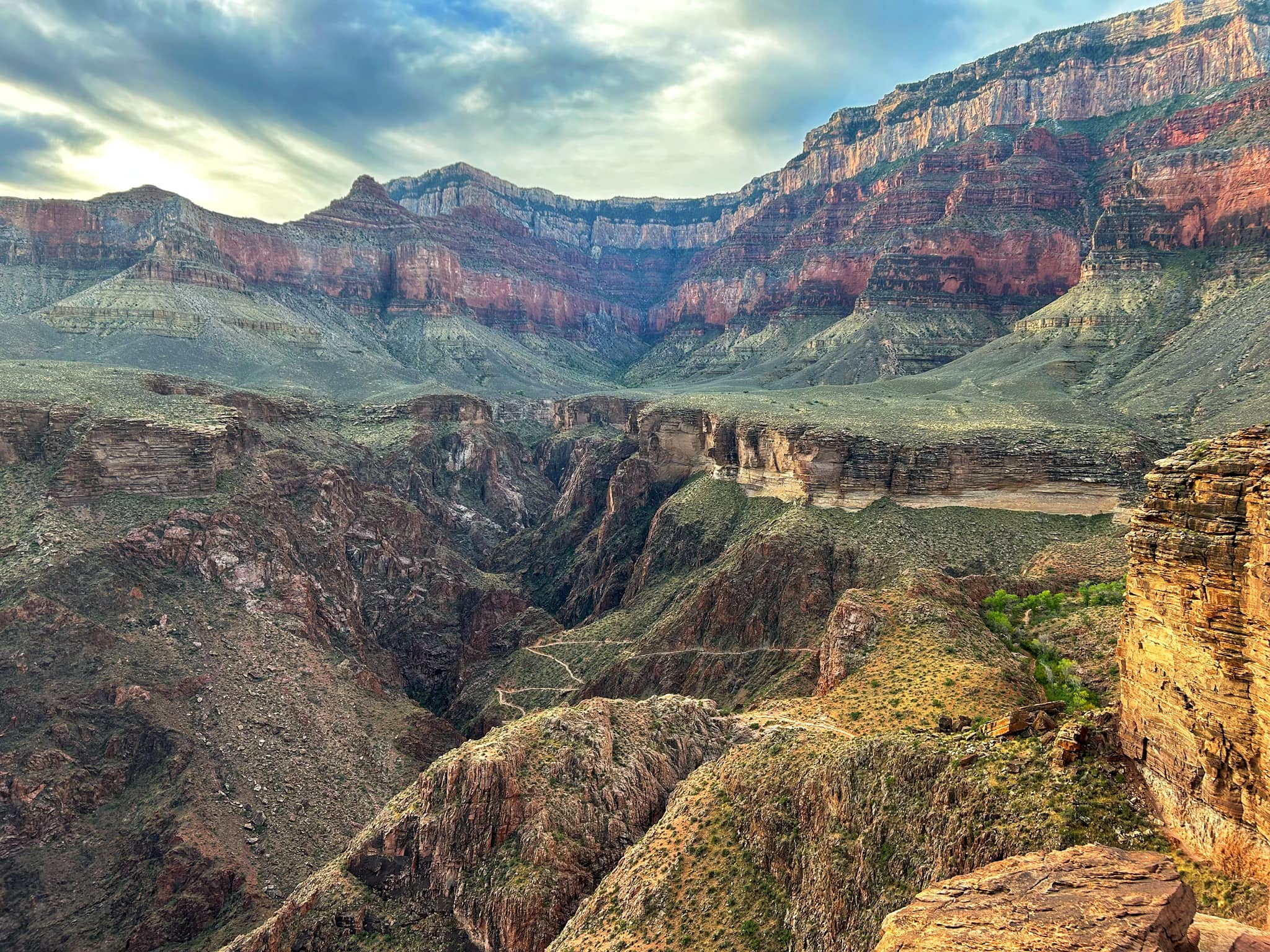 A steeply switchbacked trail cuts through steep canyon walls