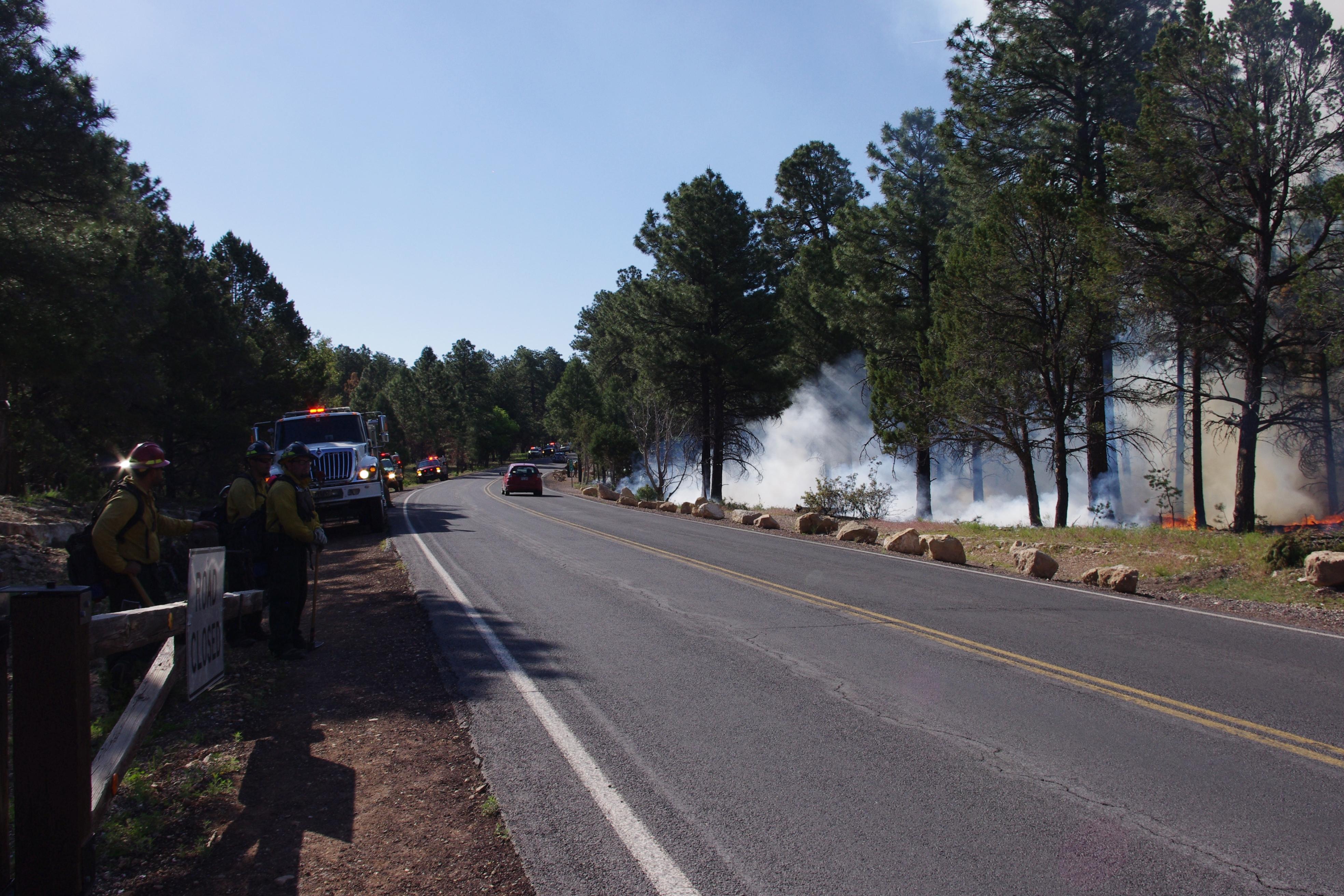 Fire personnel and equipment staged along Highway 64; smoke from Long Jim prescribed fire visible