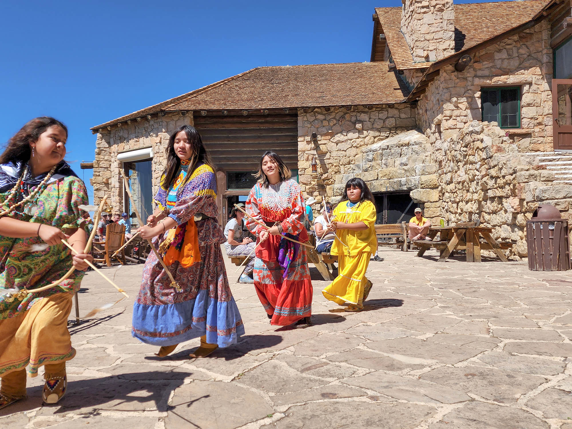 Heritage Days 2022 dancers in colorful garb on the rim of the Grand Canyon